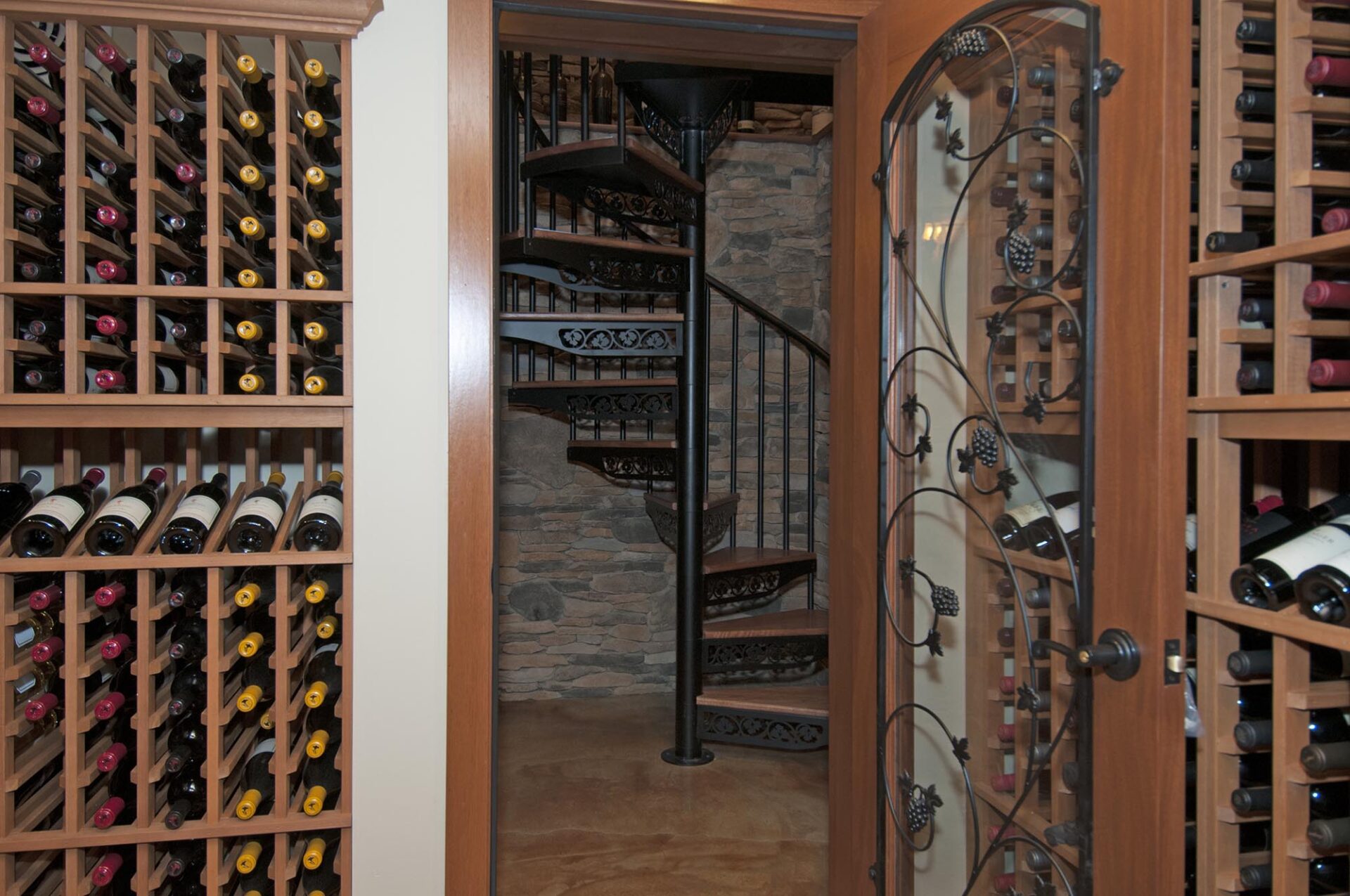 Wine cellar, Powell, Dave Fox, Remodel, spiral stairs, stacked stone, iron, wine racks