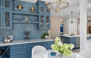 A beautifully remodeled kitchen with blue cabinets and matte gold fixtures.