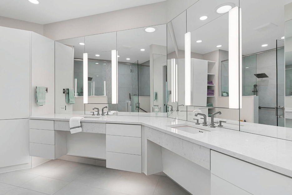 A modern bathroom remodel showing two white bathroom vanities.