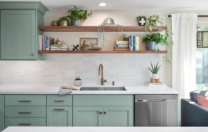 A remodeled kitchen with open shelving and pale green cabinets.
