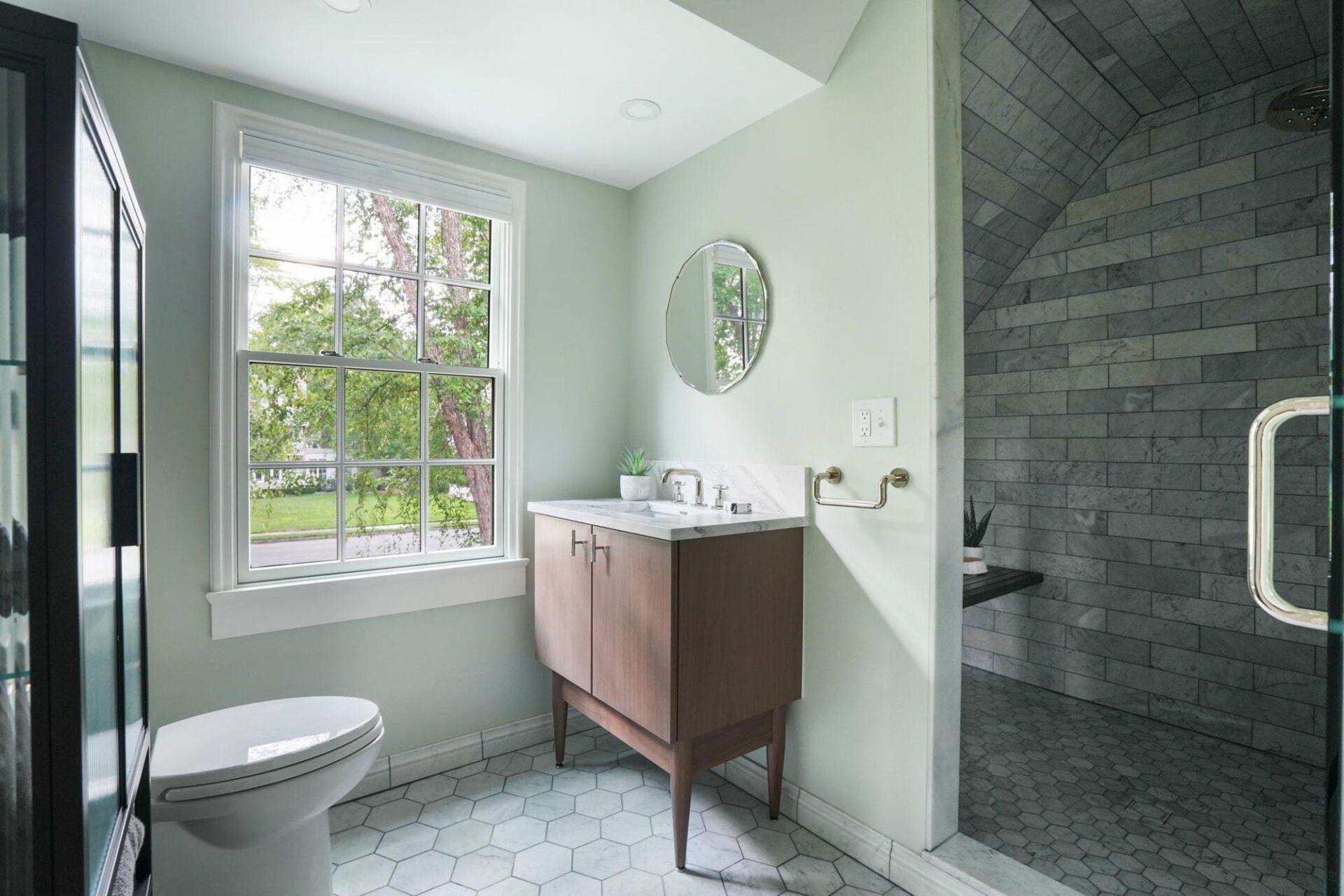 Walk-in shower with gray tile in a Bexley bathroom remodel by Dave Fox Design-Build Remodelers